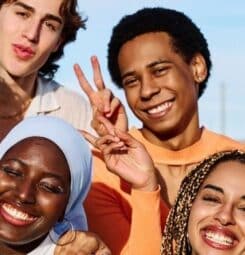 The photo shows a group of multi-ethnic and gender diverse young adults.